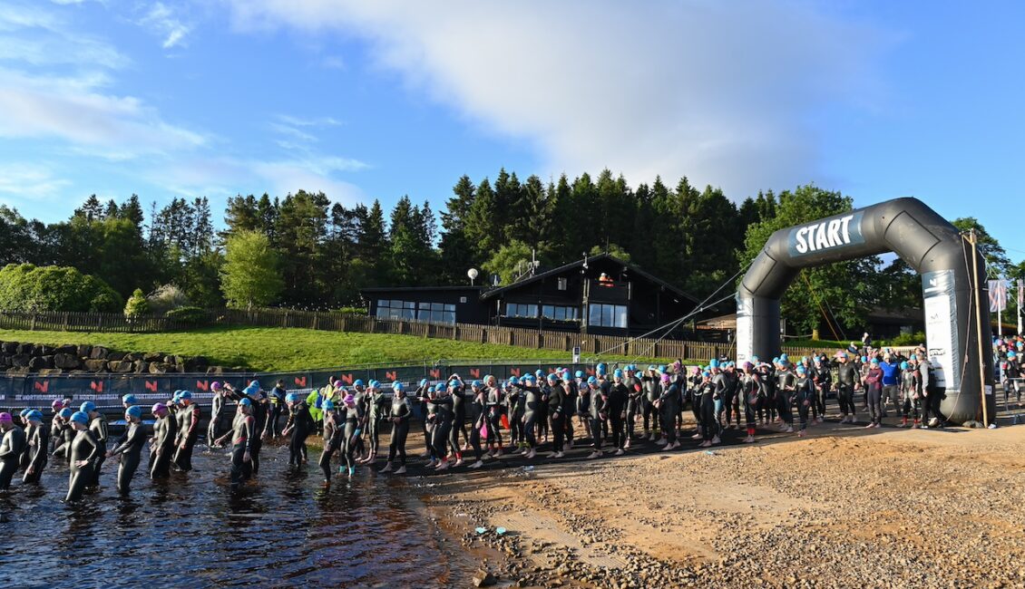 Athletes in wetsuits on the start line of The Northumbrian 2024.