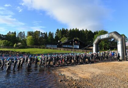 Athletes in wetsuits on the start line of The Northumbrian 2024.